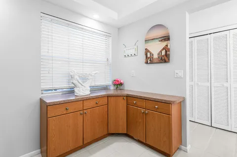 a utility room with a sink dryer and cabinets