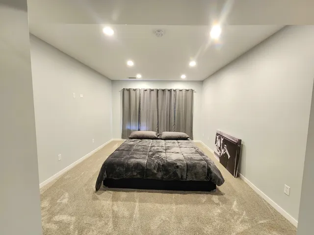 a bathroom with a shower sink vanity mirror and toilet