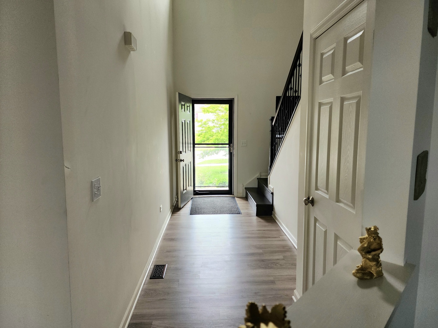 2003 Magenta Lane Algonquin, IL 60102 - Photo 3 of 29 a view of a hallway with wooden floor and staircase