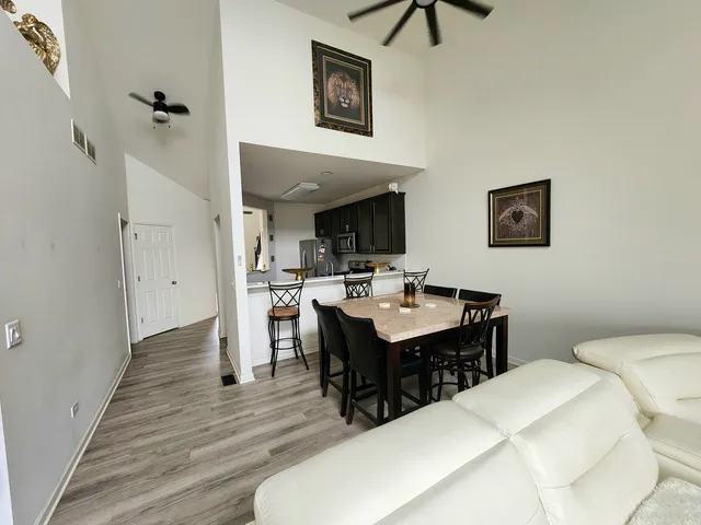 a view of a dining room with furniture and wooden floor