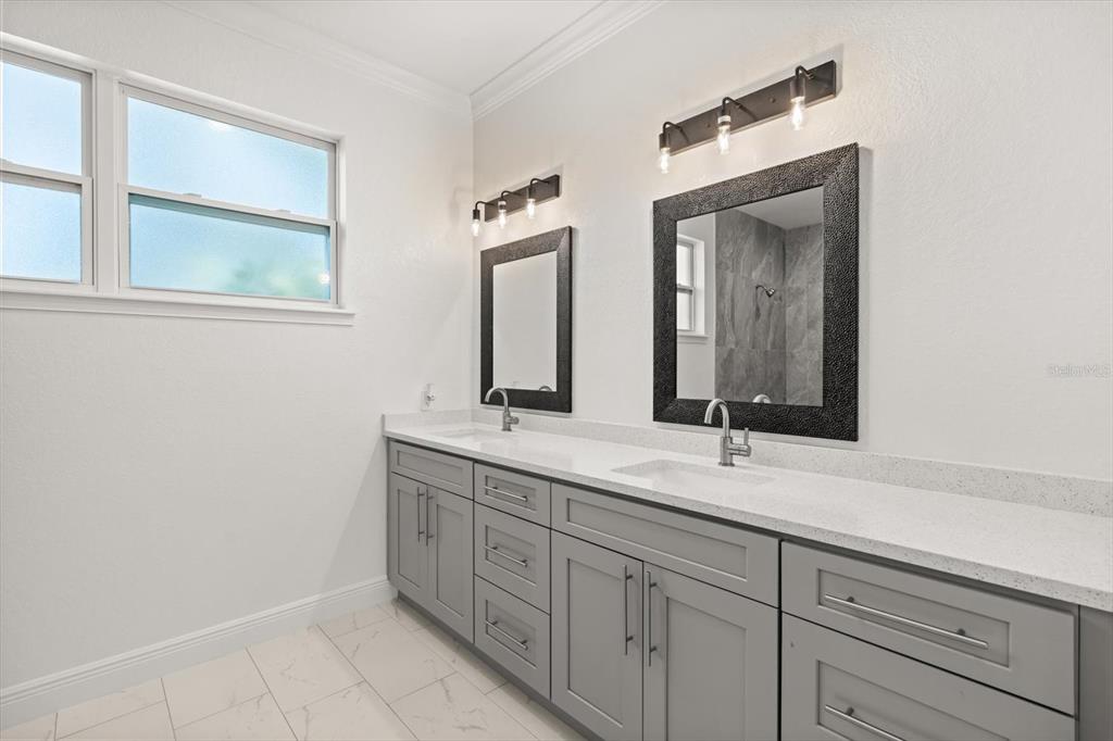840 Oaks Shores Road Leesburg, FL 34748 - Photo 12 of 25 a bathroom with a double vanity sink and a mirror