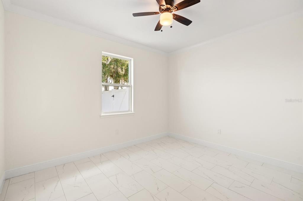 840 Oaks Shores Road Leesburg, FL 34748 - Photo 17 of 25 a view of an empty room with a window