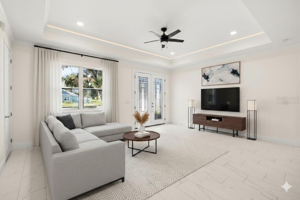 840 Oaks Shores Road Leesburg, FL 34748 - Photo 4 of 25 a living room with furniture and a flat screen tv
