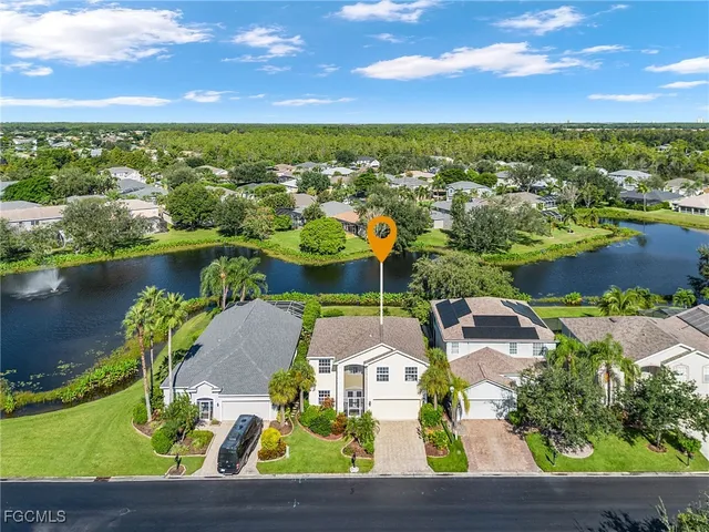 an aerial view of residential houses with outdoor space and lake view