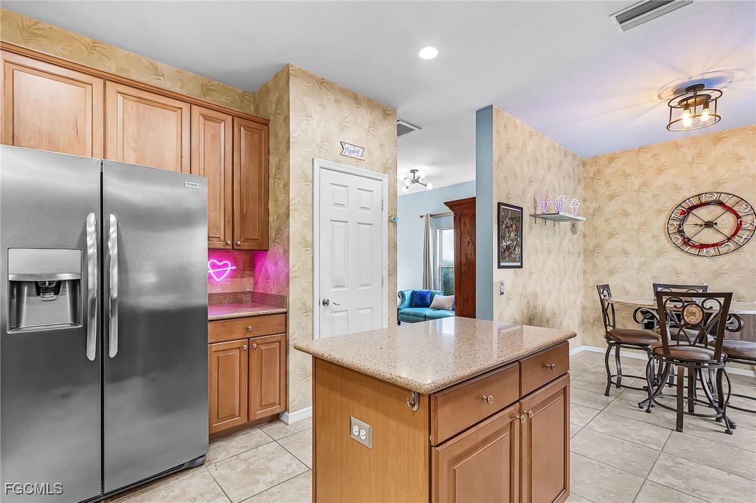 9021 Falcon Pointe Loop Fort Myers, FL 33912 - Photo 12 of 39 a kitchen with granite countertop a sink cabinets and stainless steel appliances