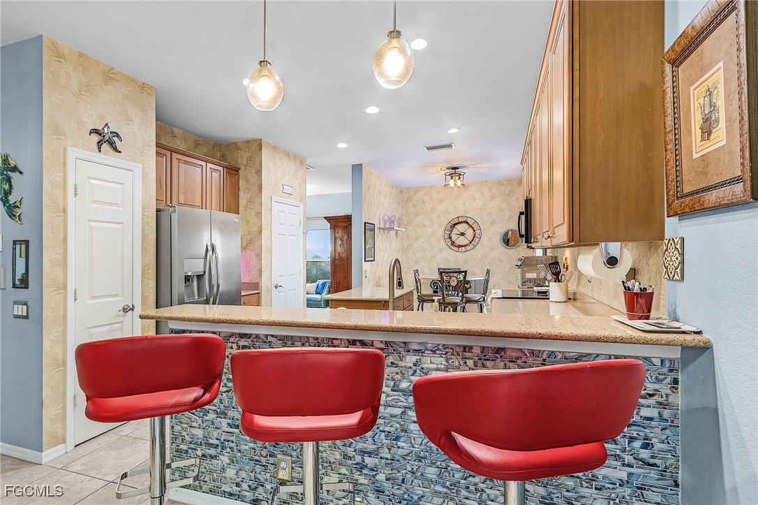 9021 Falcon Pointe Loop Fort Myers, FL 33912 - Photo 14 of 39 a bathroom with a granite countertop sink and a mirror