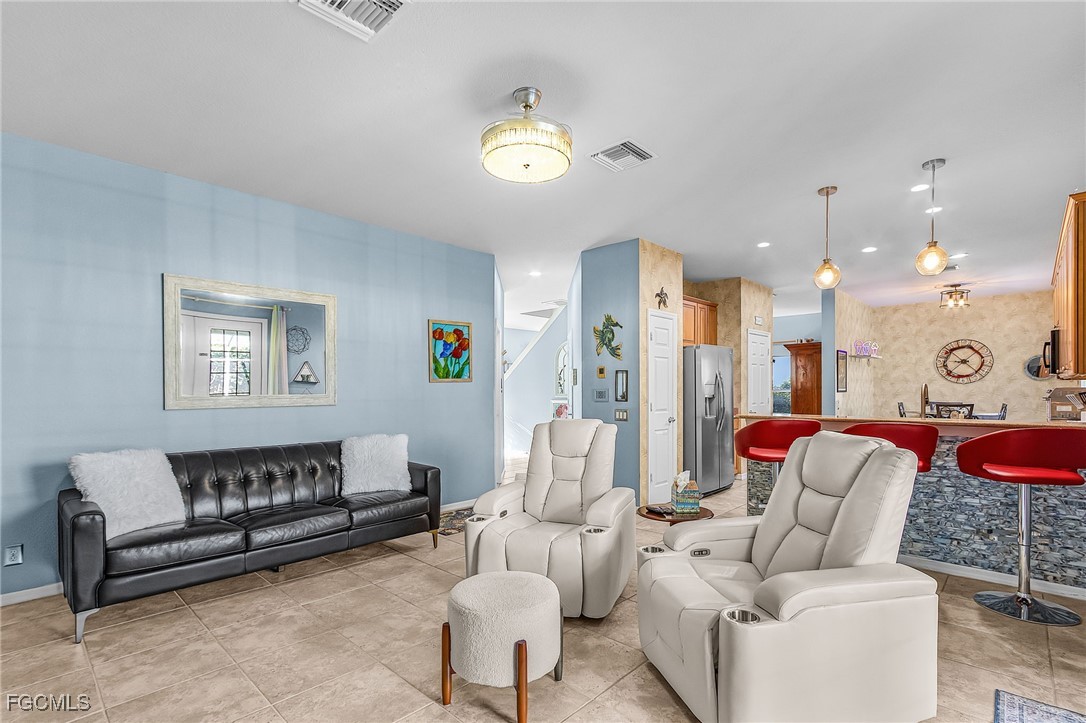 9021 Falcon Pointe Loop Fort Myers, FL 33912 - Photo 16 of 39 a living room with furniture and a chandelier