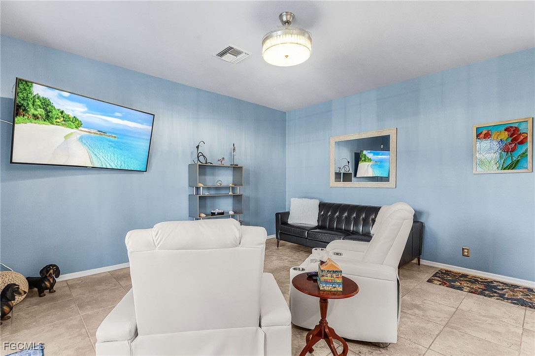 9021 Falcon Pointe Loop Fort Myers, FL 33912 - Photo 17 of 39 a living room with furniture a couch and a bookshelf