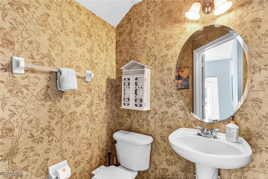 9021 Falcon Pointe Loop Fort Myers, FL 33912 - Photo 18 of 39 a bathroom with a toilet sink and mirror
