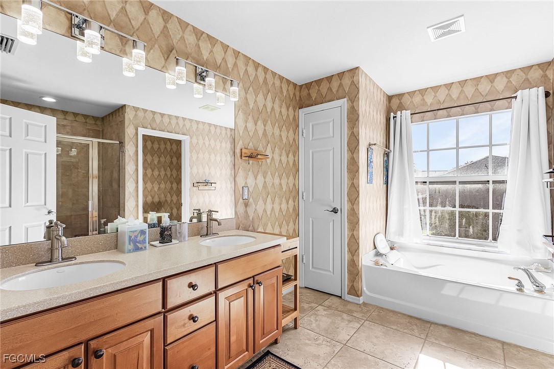 9021 Falcon Pointe Loop Fort Myers, FL 33912 - Photo 29 of 39 a spacious bathroom with sinks mirror and a shower