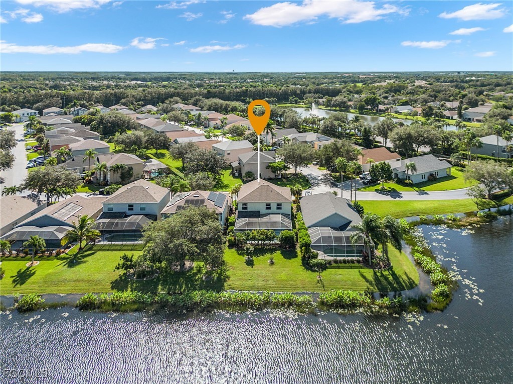 9021 Falcon Pointe Loop Fort Myers, FL 33912 - Photo 3 of 39 an aerial view of a house with a garden and lake view
