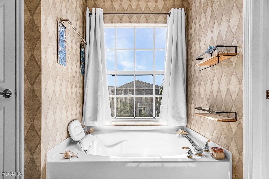 9021 Falcon Pointe Loop Fort Myers, FL 33912 - Photo 31 of 39 a bath tub sitting next to a window