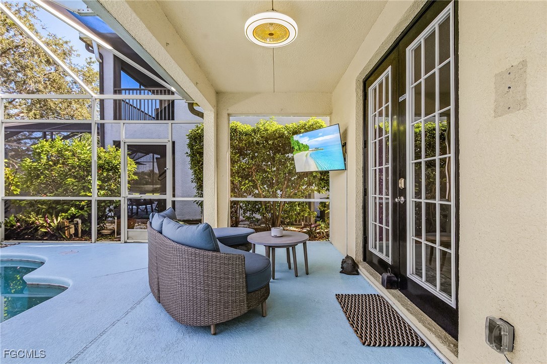 9021 Falcon Pointe Loop Fort Myers, FL 33912 - Photo 34 of 39 a living room with furniture and a floor to ceiling window