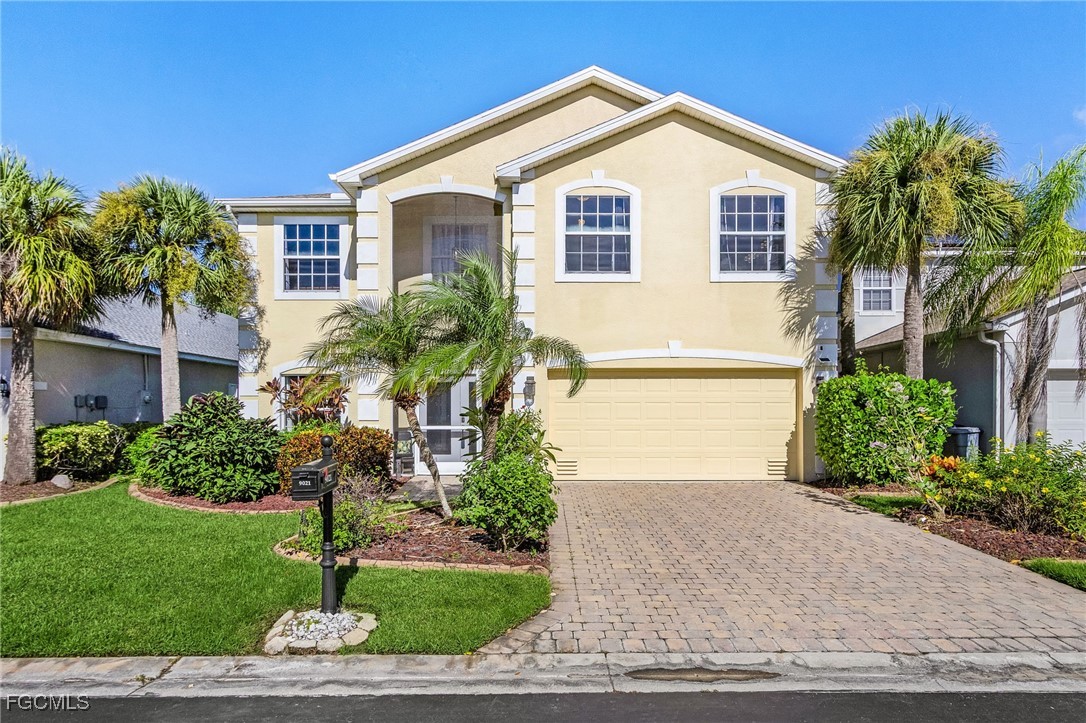 9021 Falcon Pointe Loop Fort Myers, FL 33912 - Photo 5 of 39 a front view of a house with a yard and garage