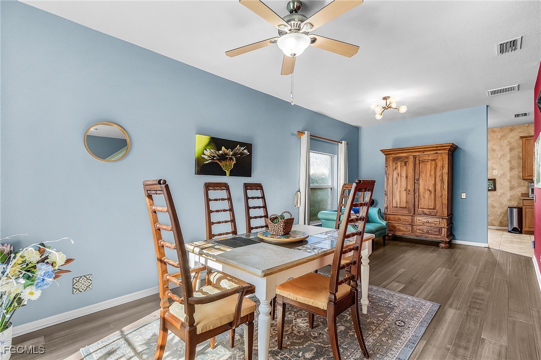 9021 Falcon Pointe Loop Fort Myers, FL 33912 - Photo 7 of 39 a view of a dining room with furniture and wooden floor
