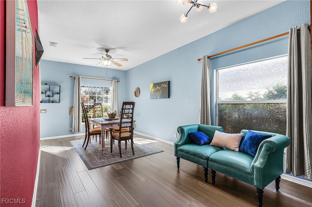 9021 Falcon Pointe Loop Fort Myers, FL 33912 - Photo 9 of 39 a living room with furniture and a wooden floor