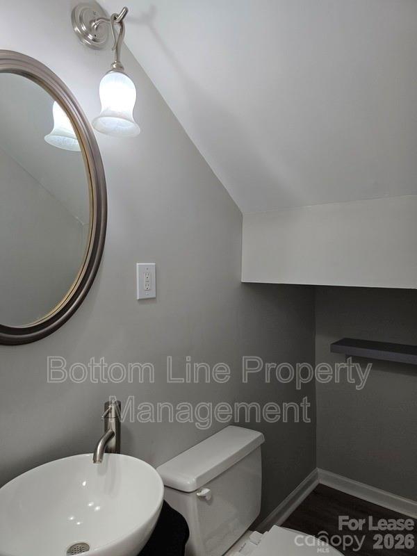 5949 Quail Hollow Road, Unit D Charlotte, NC 28210 - Photo 16 of 34 a bathroom with a toilet a sink and mirror