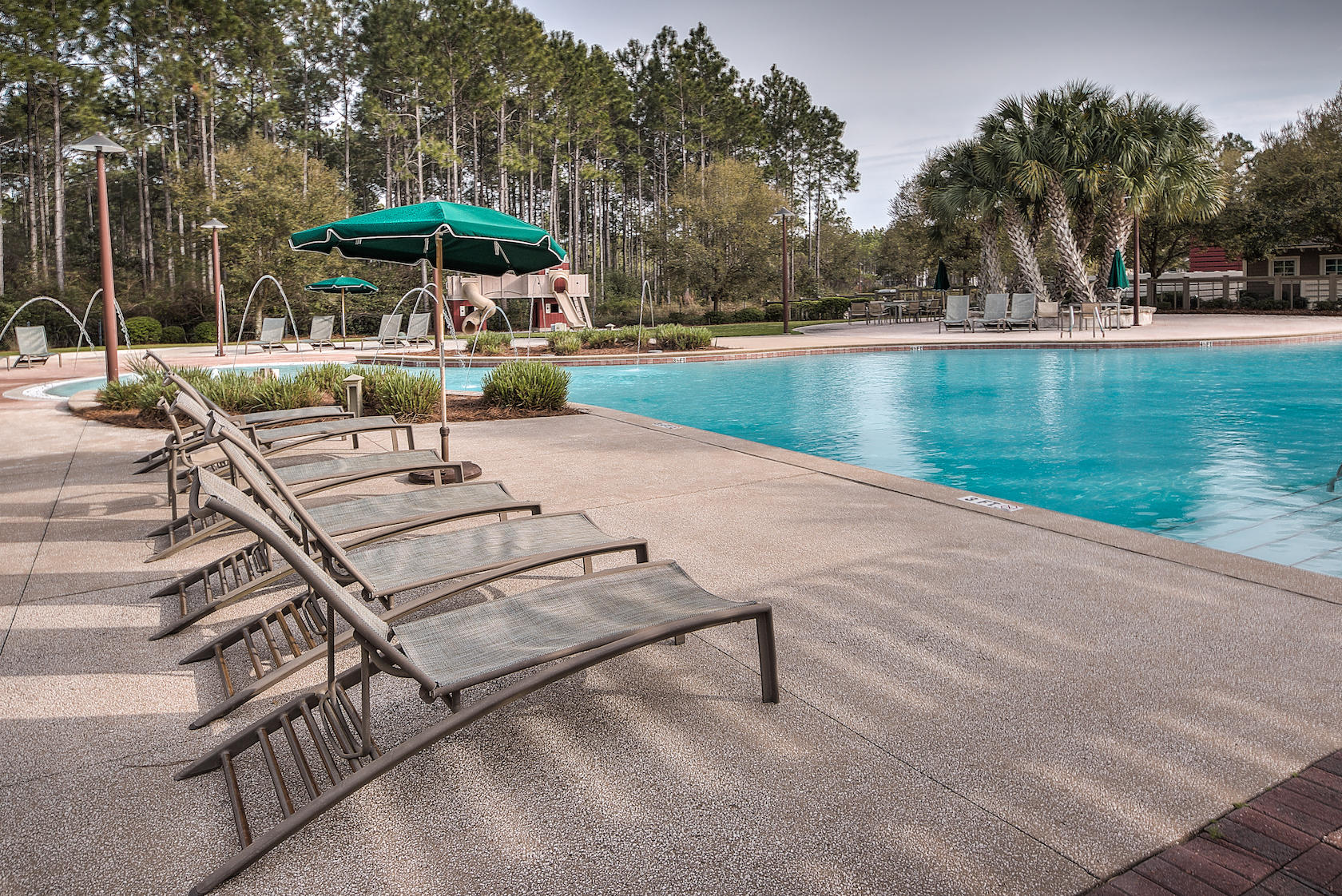 184 Sidecamp Road, Unit LOT 84 Watersound, FL 32461 - Photo 9 of 22 an outdoor space with patio and white umbrellas