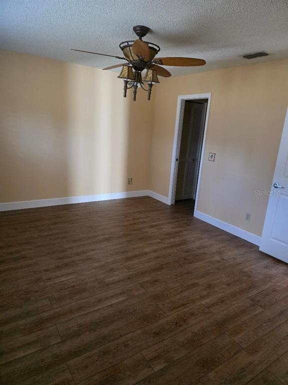 9028 Southwest 91st Circle Ocala, FL 34481 - Photo 12 of 31 a view of empty room with wooden floor