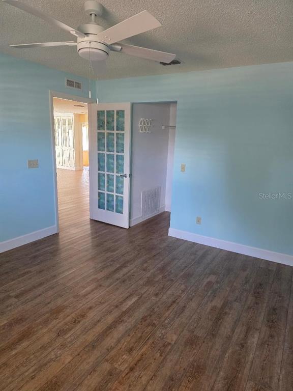 9028 Southwest 91st Circle Ocala, FL 34481 - Photo 18 of 31 an empty room with wooden floor and windows