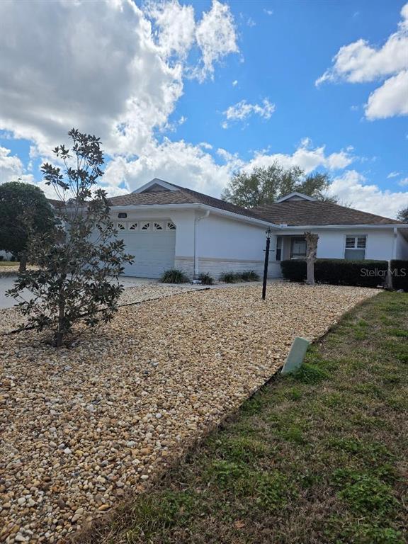 9028 Southwest 91st Circle Ocala, FL 34481 - Photo 2 of 31 a view of a house with a yard
