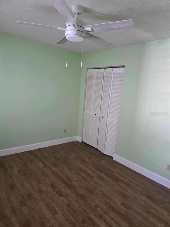 9028 Southwest 91st Circle Ocala, FL 34481 - Photo 24 of 31 an empty room with wooden floor fan and window
