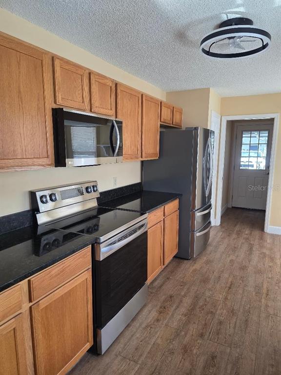 9028 Southwest 91st Circle Ocala, FL 34481 - Photo 27 of 31 a kitchen with stainless steel appliances a stove a microwave and a hard wood floors