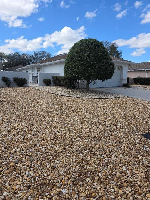 9028 Southwest 91st Circle Ocala, FL 34481 - Photo 3 of 31 a front view of a house with a yard