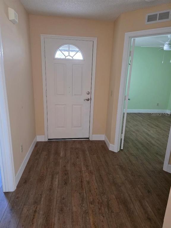 9028 Southwest 91st Circle Ocala, FL 34481 - Photo 4 of 31 an empty room with wooden floor and windows