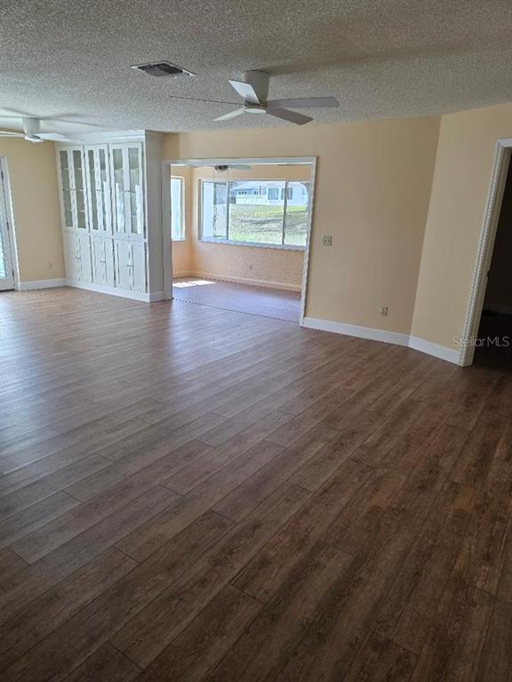 9028 Southwest 91st Circle Ocala, FL 34481 - Photo 6 of 31 an empty room with wooden floor and windows