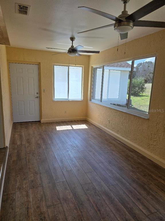9028 Southwest 91st Circle Ocala, FL 34481 - Photo 7 of 31 wooden floor in an empty room with a window