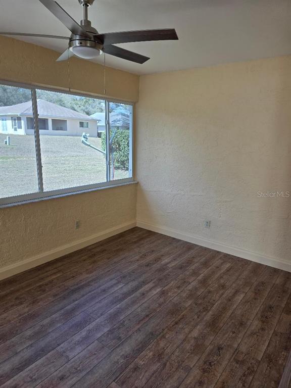9028 Southwest 91st Circle Ocala, FL 34481 - Photo 8 of 31 an empty room with wooden floor and windows