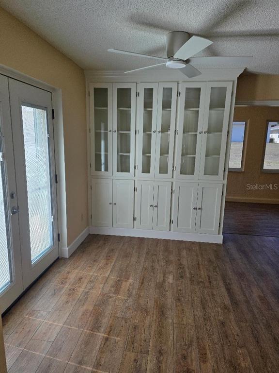 9028 Southwest 91st Circle Ocala, FL 34481 - Photo 9 of 31 an empty room with wooden floor and windows