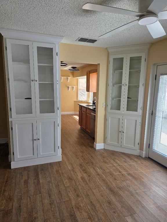 9028 Southwest 91st Circle Ocala, FL 34481 - Photo 10 of 31 an empty room with wooden floor cabinet and windows