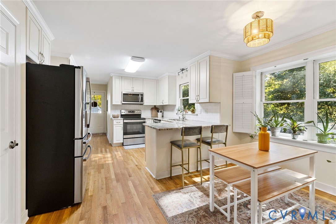 14701 Acorn Ridge Place Midlothian, VA 23112 - Photo 7 of 26 a open kitchen with stainless steel appliances kitchen island granite countertop a refrigerator and a stove top oven
