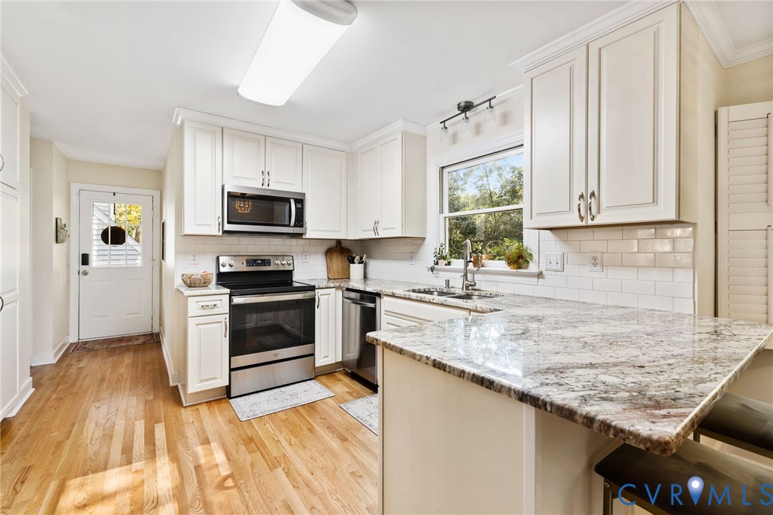 14701 Acorn Ridge Place Midlothian, VA 23112 - Photo 9 of 26 a kitchen with granite countertop a sink cabinets stainless steel appliances and a window