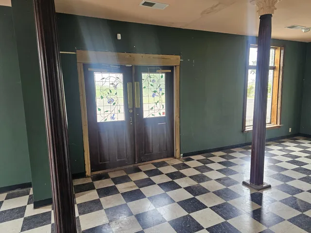 a view of a entryway with a checkered floor and a dining space