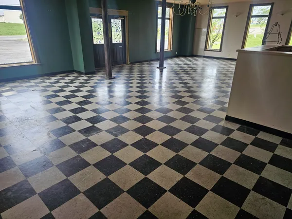 a view of a room with a black and white checkered floor