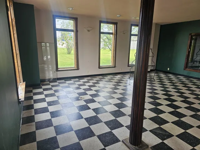 a view of a room with window and wooden floor