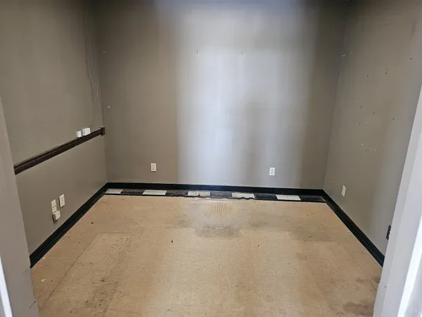 a view of hallway with kitchen and a refrigerator