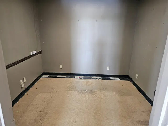 a view of hallway with kitchen and a refrigerator