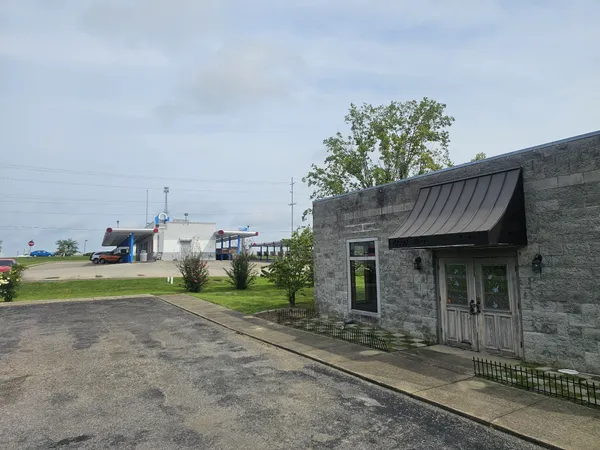 a view of a house with a yard and pathway