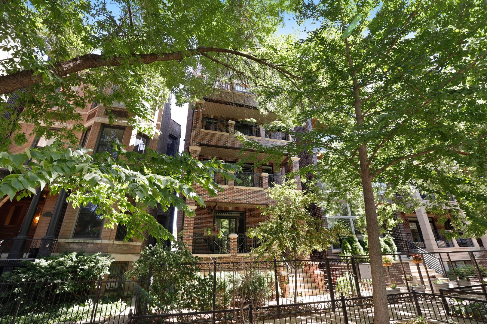 a front view of a house with a tree