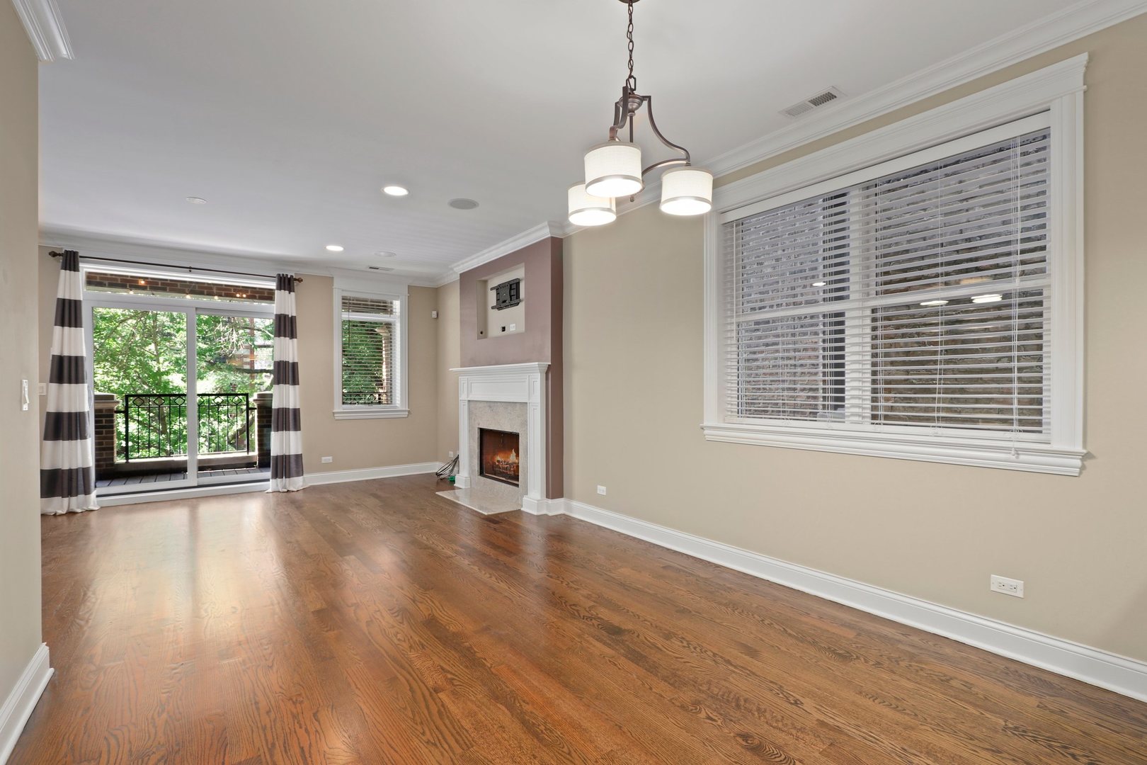 3549 North Reta Avenue, Unit 2 Chicago, IL 60657 - Photo 2 of 30 a view of an empty room with wooden floor and a window