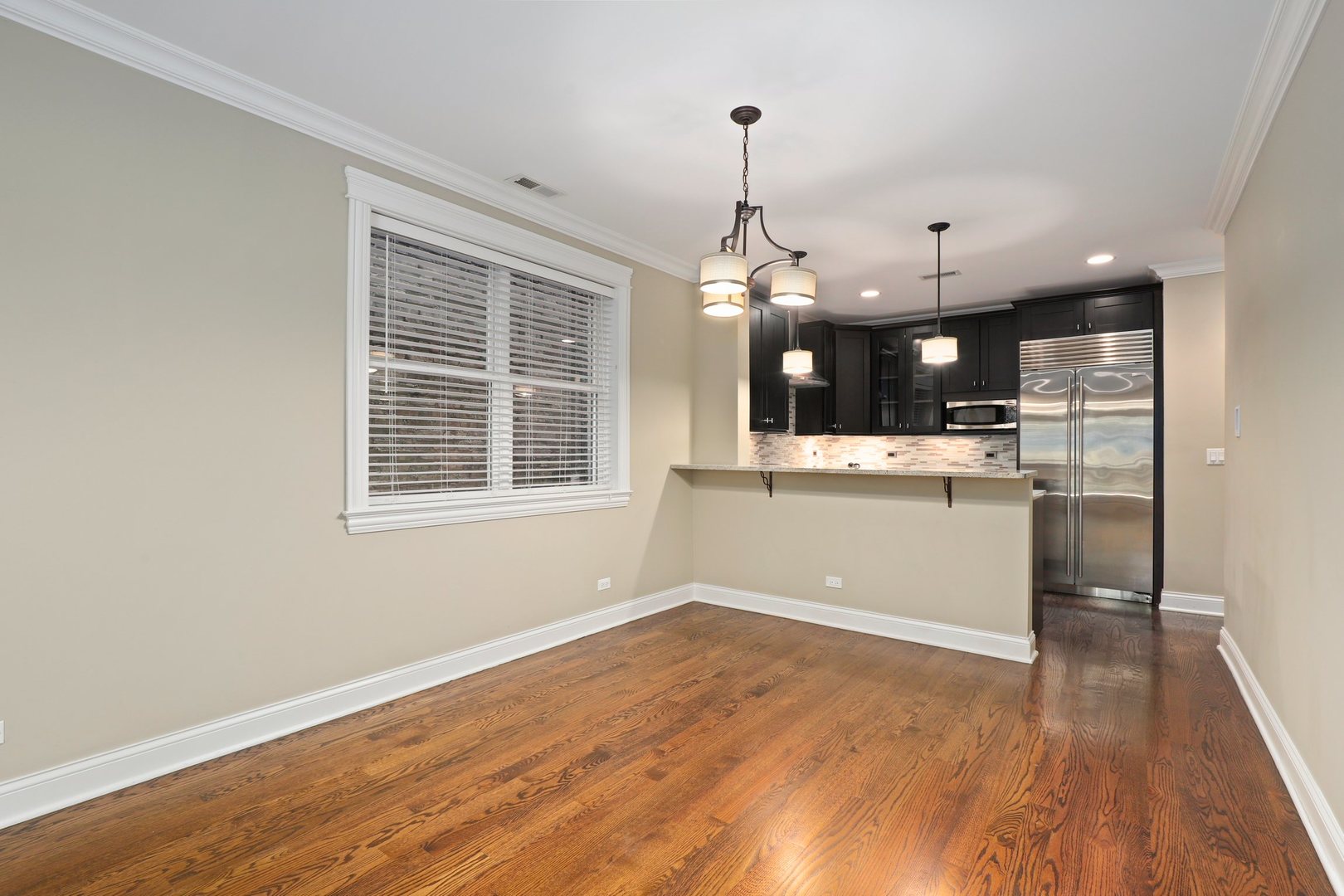 3549 North Reta Avenue, Unit 2 Chicago, IL 60657 - Photo 11 of 30 a view of a kitchen with a sink wooden floor and a window