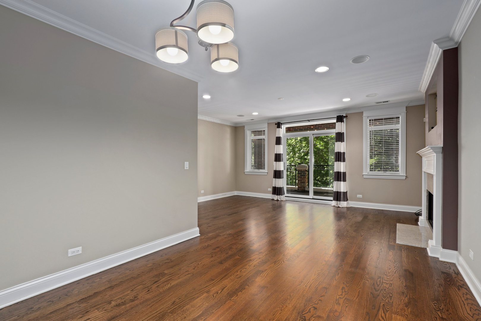 3549 North Reta Avenue, Unit 2 Chicago, IL 60657 - Photo 12 of 30 a view of an empty room with wooden floor and a window