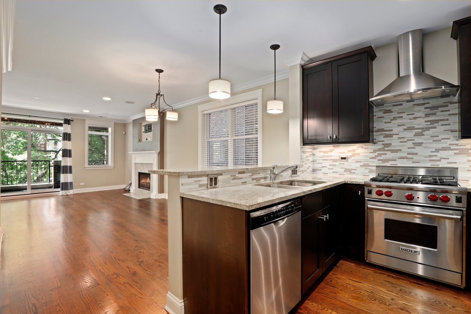3549 North Reta Avenue, Unit 2 Chicago, IL 60657 - Photo 13 of 30 a kitchen with stainless steel appliances granite countertop a stove a sink and a wooden floor