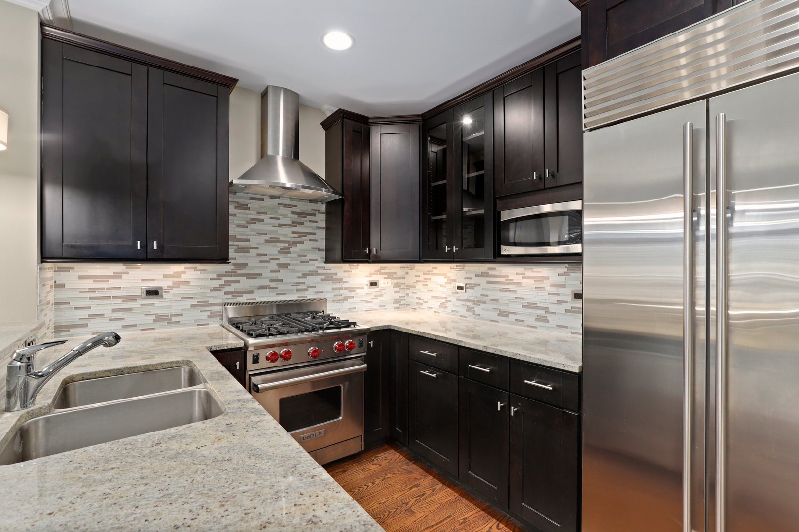 3549 North Reta Avenue, Unit 2 Chicago, IL 60657 - Photo 14 of 30 a kitchen with stainless steel appliances granite countertop a sink stove and refrigerator