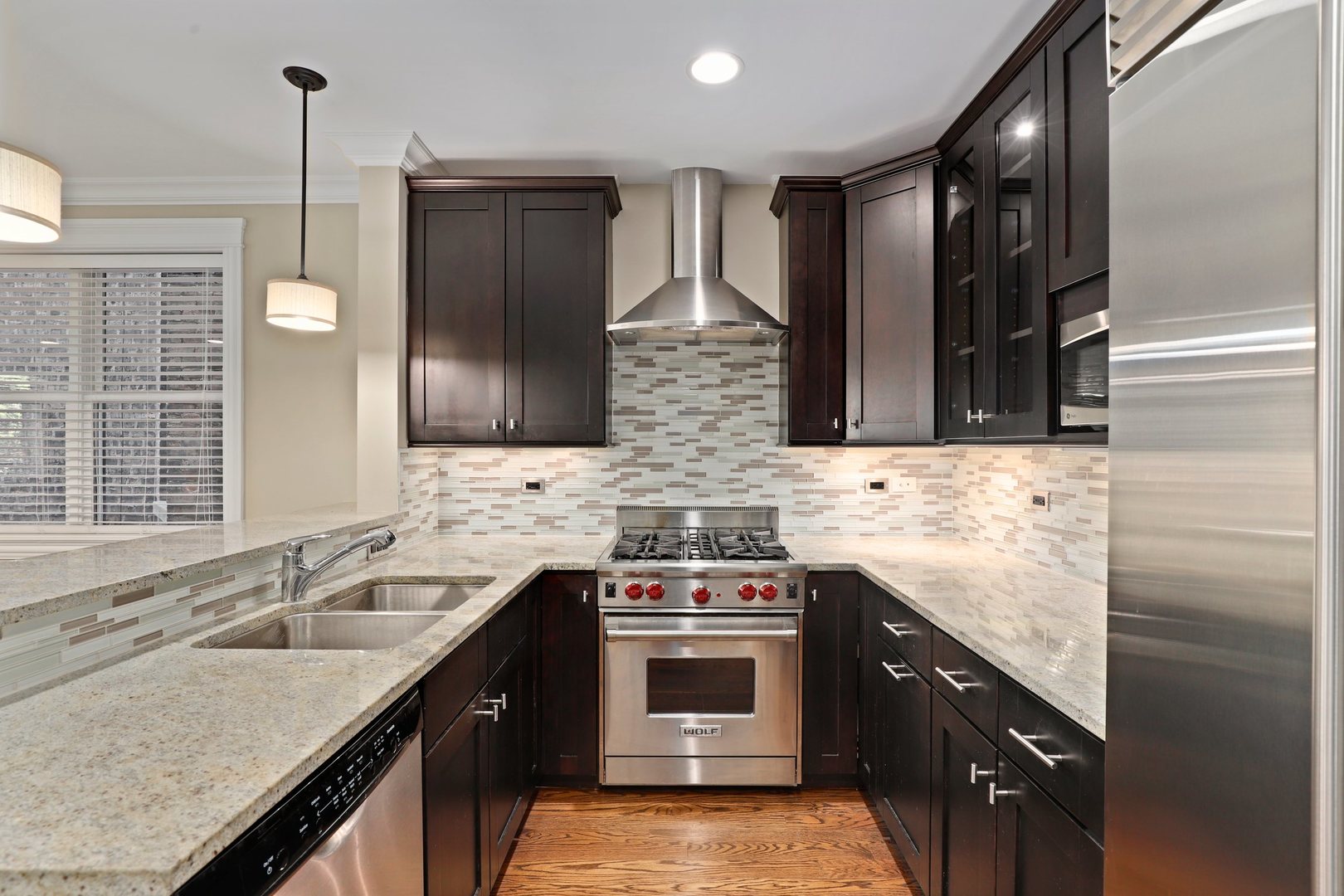 3549 North Reta Avenue, Unit 2 Chicago, IL 60657 - Photo 15 of 30 a kitchen with stainless steel appliances granite countertop a sink stove and refrigerator