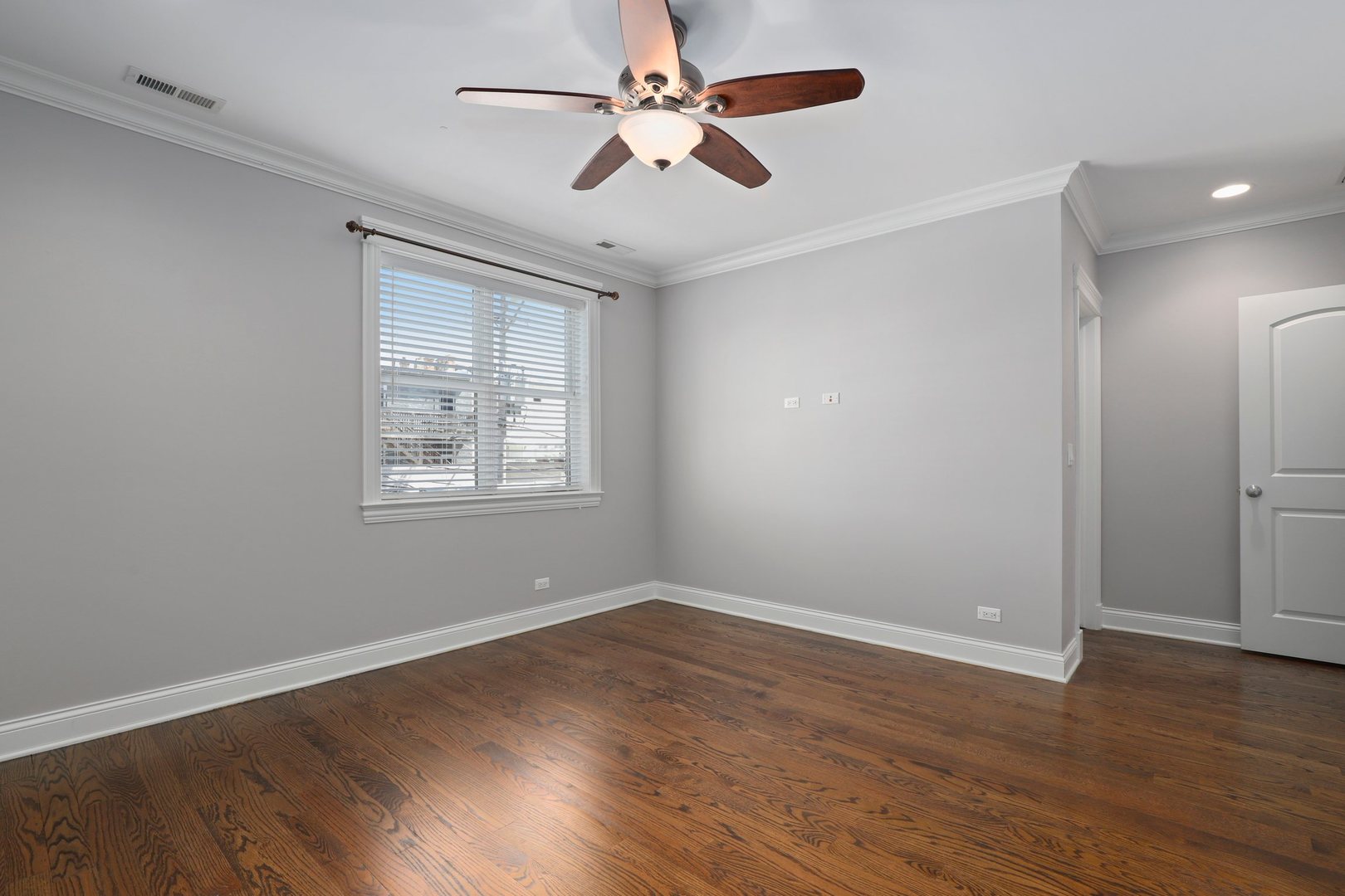 3549 North Reta Avenue, Unit 2 Chicago, IL 60657 - Photo 18 of 30 an empty room with wooden floor ceiling fan and windows